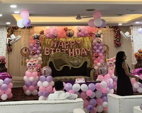 Floral stage decoration with green and pink drapes