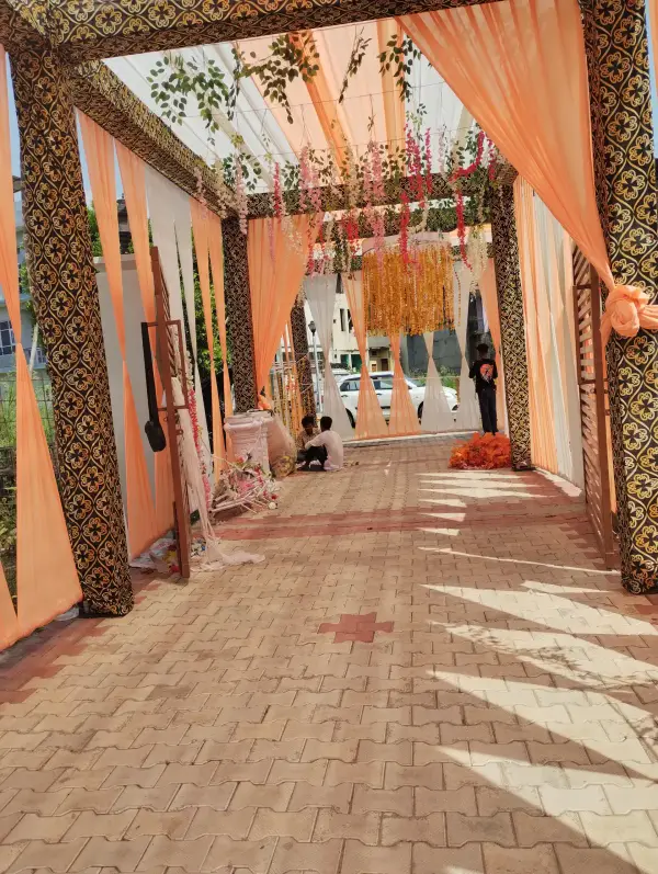 Decorated entrance walkway with hanging marigold strings